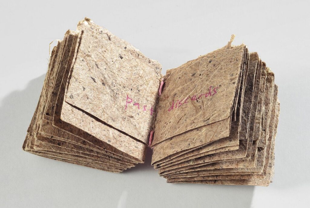 Book in a basket (2011). Pen on handmade slippery elm and dak paper, cochineal-dyed hanji and pine paper yarn. Book: 1.375 x 1.25 x 1". Oberlin College Art Library Collection.