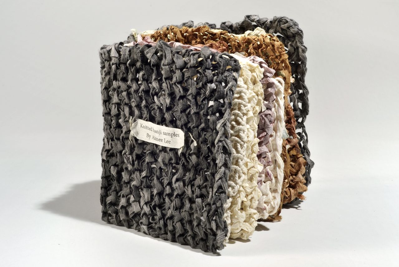 Knitted hanji samples (2011). Varied knitted hanji with natural dyes, coatings, and techniques. 5 x 4.5 x 3" closed. Artist collection.