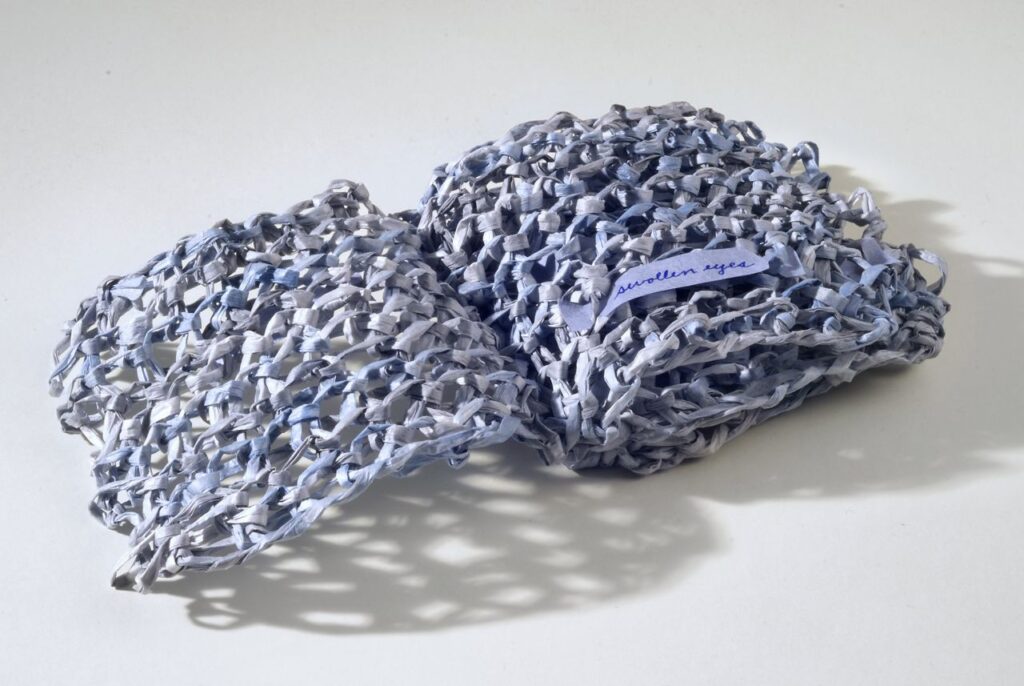 Blue (2012). Pen on hanji, knitted bamboo yarn, 4 x 4 x 1.25" closed, 8" wide open. Baylor University Crouch Library Collection.