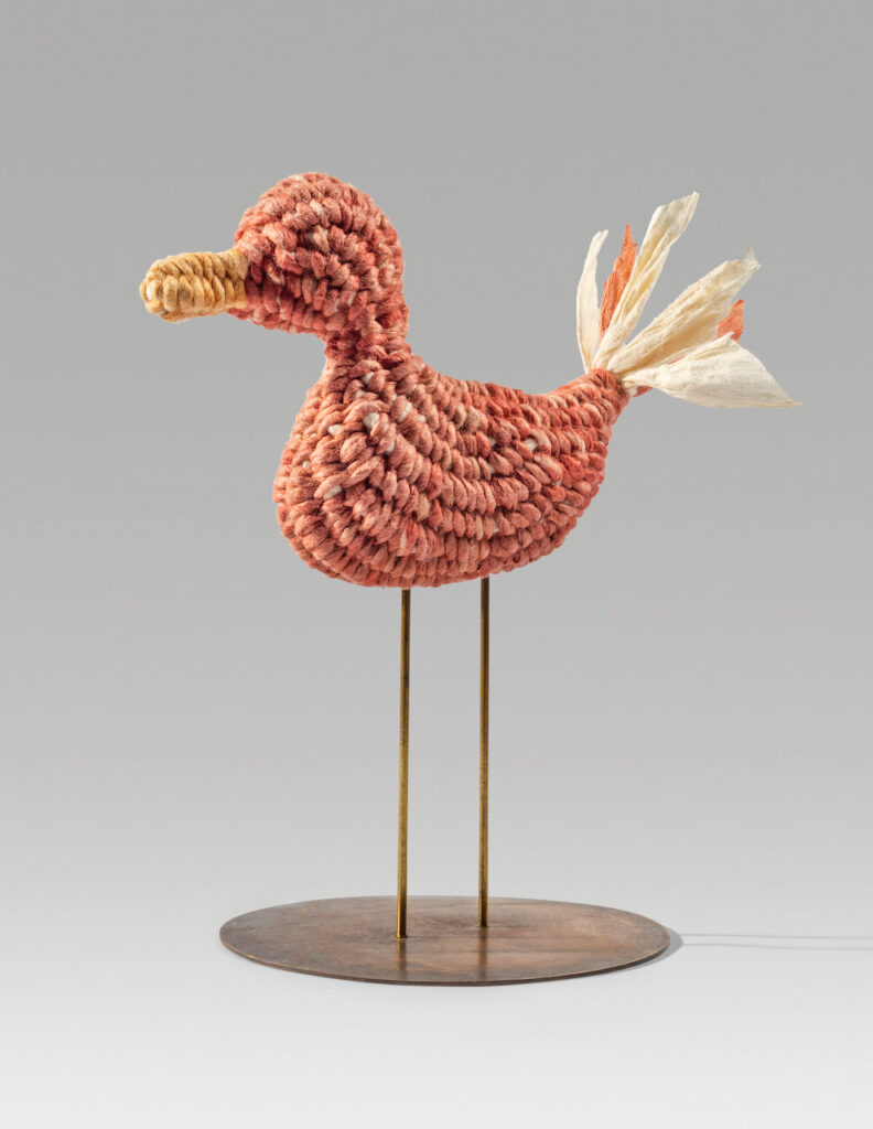 Sweet duck (2021). Natural dyes on corded and twined hanji. Duck 2.5 x 4.5 x 1”. Height on 3”-diameter stand: 4.8”. Private collection.