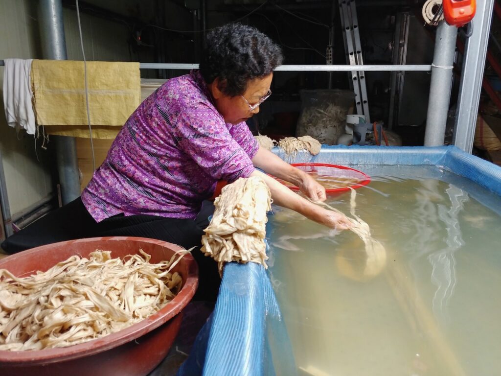 Korean woman cleans bark in large sink