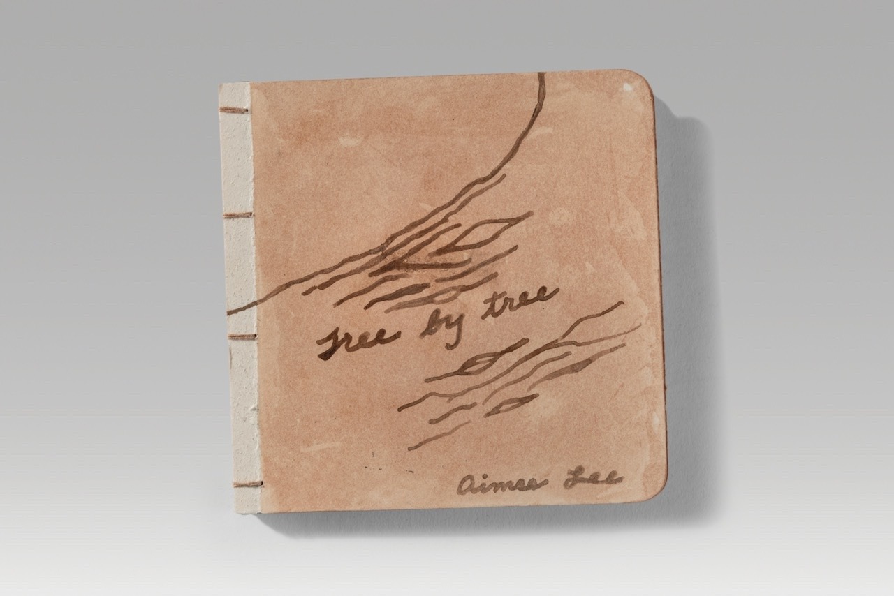 Tree by tree / board version 1 (2025). Pen, walnut dye, persimmon juice on board; silk thread. 5.4 x 5.4 x 0.4” closed, 10.9” wide open.