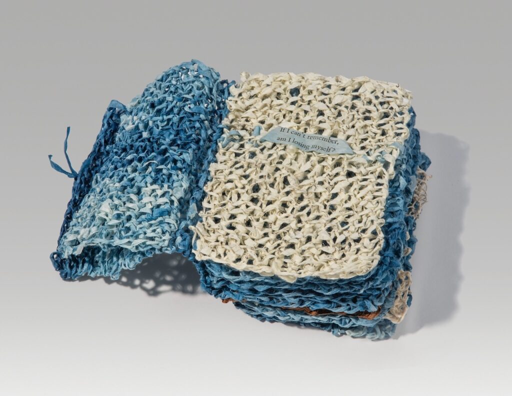 Trip (knitted version) (2025). Indigo, persimmon juice, letterpress, and pen on hanji. 4.5 x 3.75 x 3” closed, 8.5” wide open. Variable edition of 18.
